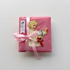 a pink wrapping paper with a little angel on it