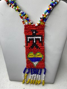 Here's an absolutely beautiful First Nations beaded necklace. The necklace is made out of plastic which leads me to believe it's old, but not super old. The length is around 25" and the necklace is in great shape. It does not open, so it's slip on. Also it is reversible and can be worn on both sides  Please message me with any questions Southwestern Beaded Pendant Necklace, Southwestern Beaded Necklaces As Gift, Southwestern Beaded Necklaces For Gift, Southwestern Style Beaded Necklaces For Gifts, Traditional Multicolor Heart Beads Necklace, Bohemian Beaded Heart Pendant Necklace, Traditional Multicolor Jewelry With Heart Beads, Southwestern Beaded Chain Necklace For Festivals, Red Beaded Necklaces With Heart Beads For Festivals