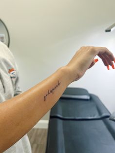 a woman's arm with a tattoo that reads, i love you in cursive writing