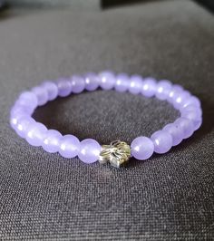 ️ Made with durable, pre-stretched crystal elastic for a perfect fit. ️ Made with lavender 6mm chalcedony stone beads with a lotus flower spacer bead in the middle.  ️ Beautiful in the light. ️ Slight color variations may occur due to flash used in photography and photo enlargement. ️ Bracelet will be shipped within 1 to 3 days except holidays. 📬 ️ If you have any questions, please don't hesitate to contact me. I will do my best to reply as soon as possible. Spiritual Lavender Beaded Bracelets As Gift, Lavender 8mm Beads Bracelet Gift, Lavender Crystal Bracelet With 8mm Beads As Gift, Lavender Beaded Bracelets With 8mm Beads For Gift, Lavender Beaded Bracelets With Round Beads As Gift, Lavender Bracelets With Spacer Beads As Gift, Lavender Bracelets With Spacer Beads For Gift, Lavender Bracelet With 8mm Beads For Meditation, Lavender Gemstone Beaded Bracelets As Gift