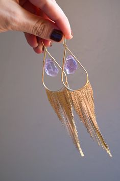 Our most popular crystal fringe statement earrings now come with Amethyst crystals. These unique tassel earrings look stunning when the light dances off of them! They are the perfect bridal or bridesmaids earrings or would make a great gift for yourself or a girlfriend. Amethyst is a stone of intuition, connecting you to your inner wisdom, empowering you to trust yourself! Amethyst crystals *color of purple amethyst is lighter purple and ranges in lightness Gold fringe earrings Weight: .22 oz Dr Crystal Fringe, Chakra Gifts, Bridesmaids Earrings, Gold Fringe, Amethyst Crystals, Inner Wisdom, Raw Amethyst, Crystal Suncatchers, Crystal Accessories