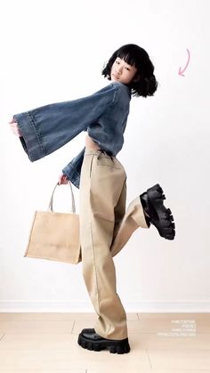 a woman is holding a shopping bag and jumping in the air with her legs spread out