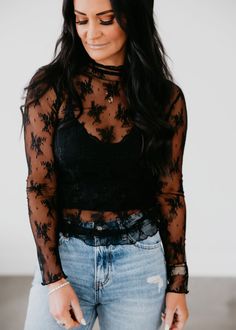 The Kalin Lace Mesh Top combines elegant lace and airy mesh for a sophisticated look. Complete with long sleeves and a mock neckline. Laurie is wearing a size small. Measurements: Body Length: 25.5" | Sleeve Length: 25" Small: Bust: 32" Arm: 10" Medium: Bust: 33" Arm: 11" Large: Bust: 34" Arm: 12" 90% Nylon 10% Spandex How To Style A Mesh Top, Lace Shirt Outfits, How To Style Lace Top, Birthday Tops For Women, Long Sleeve Lace Top Outfit, Mesh Undershirt Outfit, Black Lace Shirt Outfit, Lace Top Outfit Aesthetic, Lace Top Outfit Ideas