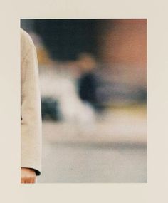 a polaroid photograph of a man walking down the street