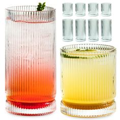 several glasses with different colored liquids in them next to each other on a white background