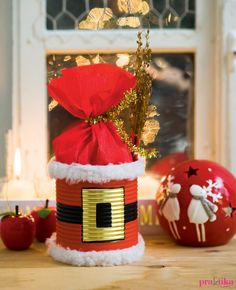 a red santa hat sitting on top of a wooden table