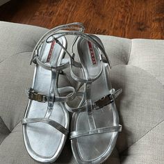 Prada Kitten Heel Silver Sandals. Worn A Few Times In Exceptional Condition. Please Ask Questions And Examine Pics. Velcro Strap Closure. Silver Patent Leather Sandals With Heel Strap, Luxury Silver Patent Leather Sandals, Prada Silver Heels, Elegant Silver T-strap Sandals, Luxury Women's Sandals With Silver-tone Hardware, Silver Sandals, Silver Heels, T Strap, Velcro Straps