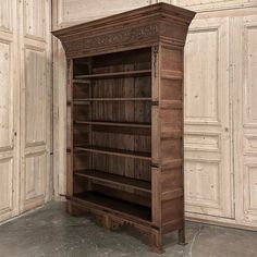 an old wooden bookcase in the corner of a room