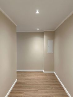 an empty room with hard wood flooring and white paint on the walls is shown