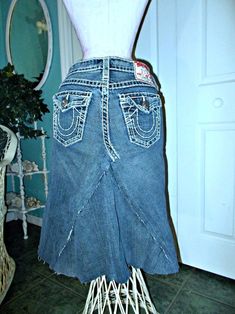 "This listing is for one of my line of Renaissance Denim Couture, where I upcycle denim and give it new life with French bohemian flair. This \"bohémienne\" jean skirt features a dark wash authentic True Religion denim skirt in a size 28 waist that I upcycled from vintage jeans. I frayed the edges and the hem for a funky boho vibe. This fraying will get even better with each wash! The size 28 waist of the Renaissance Denim Couture jean skirt has an actual measurement of 30\", with 38\" hips and Fitted Denim Hippie Bottoms, Hippie Fitted Denim Bottoms, Fitted Upcycled Denim Bottoms, Fitted Medium Wash Bottoms For Festival, Fitted Bohemian Dark Wash Jeans, Fitted Cotton Denim Skirt With Unfinished Hem, Fitted Denim Skirt With Unfinished Hem, Bohemian Cotton Denim Skirt With Frayed Hem, Bohemian Fitted Medium Wash Bottoms