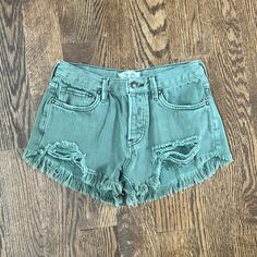 Never Worn Green Denim Jean Shorts For Spring, Spring Green Denim Jean Shorts, Trendy Green Cutoff Shorts, Ripped Green Cotton Bottoms, Green Denim Jean Shorts With Pockets, Green Shorts With Frayed Hem, Green Summer Bottoms With Frayed Hem, Trendy Green Cutoff Jean Shorts, Summer Green Bottoms With Frayed Hem