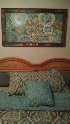 an image of a bed with pillows and a painting on the wall above it that says send