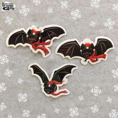 two stickers with bats on them and snowflakes in the background