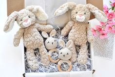 two stuffed animals in a box with flowers