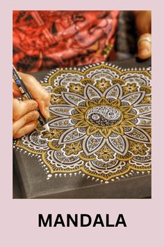 a person is drawing on a piece of paper with the words,'mandala '