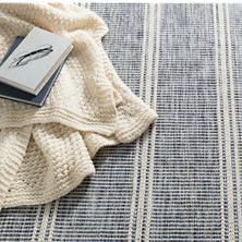 a book is laying on top of a blue and white blanket with a feather drawn on it