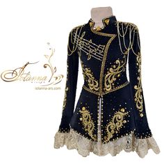 a woman's black and gold ballroom dress with laces on the bottom, long sleeves