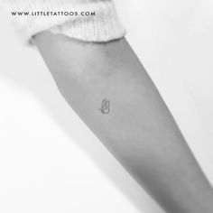 a woman's arm with a small tattoo on the left side of her arm