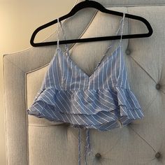 Super Cute White And Blue Patterned Tank. Tighter In Chest Area And Has Ruffles Under Near Stomach. Super Cute In Summer With White Jeans/ Shorts. Never Worn Fitted Ruffle Hem Crop Top For Summer, Blue Ruffle Hem Top For Beach, Forever 21 Cotton Ruffle Top, Forever 21 Sleeveless Tops With Ruffles, Forever 21 Ruffled Top For Brunch, Trendy Blue Ruffled Crop Top, Blue Fitted Ruffle Crop Top, Fitted Blue Ruffle Crop Top, Trendy Blue Tops With Ruffle Hem