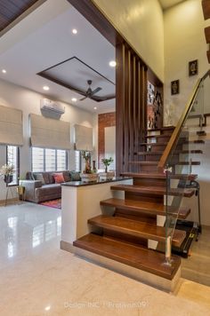 a living room filled with furniture and stairs