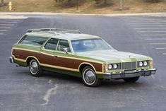 an old station wagon is parked in a parking lot with no one around the car