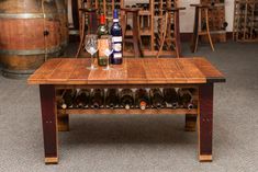 a wooden table with wine bottles and glasses on it