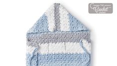 a blue and white crocheted blanket on a white background