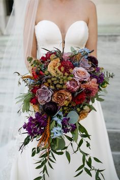 a bride holding a bouquet of flowers in her hands