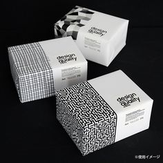 three boxes with black and white designs on them