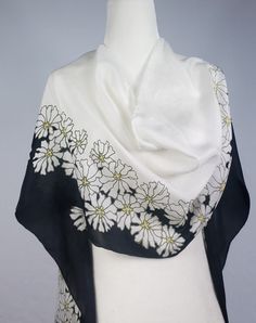 Approximately 14 X 72 inches 35cmX183cm Handmade, hand painted 100% habotai silk scarf. White daisies are all over this scarf, on a black/white background. This shawl is the perfect size for versatile styling. And it would make a wonderful gift. **Care Instructions** Handwash in cold water with a mild soap, do not soak the scarf. Pat dry with a fluffy bath towel, and hang straight to dry. Iron on a low heat setting while scarf is damp, under a cotton cloth. Note: If ironing scarf with metallic g White Artistic Scarves For Spring, Artistic White Scarf For Spring, Artistic White Scarves For Spring, Artistic White Silk Scarf For Summer, White Silk Shawl Scarf For Summer, Black Silk Scarf With Floral Print, Black Silk Scarves With Floral Print, Black Summer Shawl Scarf, Black Shawl Scarf For Summer