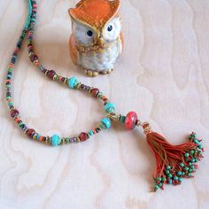 Another piece from the Turquoise Coral Collection comes this amazing, long beaded tassel necklace.  Wire wrapped beaded tassel is the focal point for this beautiful piece. Mixed matching and complementary colors of turquoise green and terracotta red/orange coral colors. Metal finish available in Gold or Vintage Bronze. Choose your perfect length at checkout. Want more of the look? Check out all of the matching earrings and necklaces in the shop by searching Turquoise Coral Collection, or have a custom piece made. This necklace comes gift wrapped/boxed at no extra charge. Sending to a friend? I'll even write on the tag for you. Ships Free to the U.S. and Puerto Rico. Discounted International shipping. Keep the Beach in Your Life! Bohemian Tassel Necklace For Festivals, Turquoise Jewelry With Tassels And Round Beads, Adjustable Bohemian Tassel Necklace, Bohemian Hand-strung Turquoise Necklace For Festivals, Bohemian Turquoise Necklace With Colorful Beads For Gift, Bohemian Multicolor Tassel Necklace With Colorful Beads, Bohemian Long Tassel Necklace As A Gift, Bohemian Long Tassel Necklace, Spiritual Beach Necklaces With Tassels