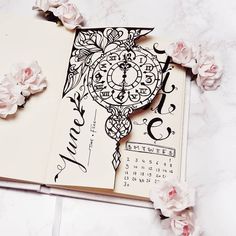 an open book with some drawings on it and flowers around the pages that have been drawn