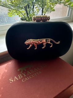 Elevate your style with our Sabyasachi-inspired premium clutch, a true embodiment of luxury and elegance. This exquisite clutch is designed to complement any outfit, making it perfect for weddings, parties, and special occasions. Crafted with meticulous attention to detail, it combines traditional aesthetics with contemporary design, ensuring you stand out wherever you go. Shipped in a designer box with Sabya Logo Product Features: Design: Inspired by the iconic Sabyasachi style Quality: Premium craftsmanship and materials Material: faux leather, velvet, textured pattern Detailing: Intricate embroidery/beading with exquisite finish Closure: Secure clasp closure Interior: Spacious and cloth lined with designer stamping inside as well can fit iPhone inside, even ProMax (if you have a wallet Luxury Handwork Elegant Clutch, Traditional Luxury Handmade Clutch, Elegant Luxury Handwork Clutch, Sabyasachi Clutch, Traditional Embellished Pouch Clutch, Designer Handbags, Modern Outfits, Backpack Purse, Exquisite Design