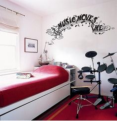 a bedroom with red carpet, white walls and lots of musical equipment on the floor