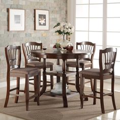 a dining room table with four chairs around it