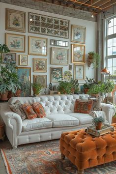 a living room filled with furniture and lots of pictures on the wall above it's windows