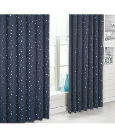 curtains with stars on them are hanging in front of a window