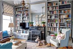 a living room filled with furniture and bookshelves covered in lots of bookcases