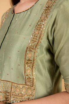 Olive green chanderi silk kurta with sequins embroidered front placket. Paired with pant in sequins embroidery along the hem.
Component: 2
Pattern: Embroidered
Type Of Work: Sequins, Floral
Neckline: Round
Sleeve Type: Short sleeves
Fabric: Chanderi silk
Color: Green
Other Details: 
Sequins embroidered cuffs and bodice
Note: Dupatta worn by model is not for sale
Occasion: Puja, Mehendi - Aza Fashions Green Slub Silk Salwar Kameez With Mirror Work, Green Salwar Kameez With Mirror Work In Slub Silk, Mirror Work Slub Silk Palazzo Set For Festivals, Slub Silk Palazzo Set With Mirror Work For Festivals, Silk Kurta With Gota Work For Reception, Chanderi Kurta For Reception And Festivals, Transitional Silk Palazzo Set With Mirror Work, Green Cotton Silk Churidar With Gota Work, Green Slub Silk Dupatta With Mirror Work