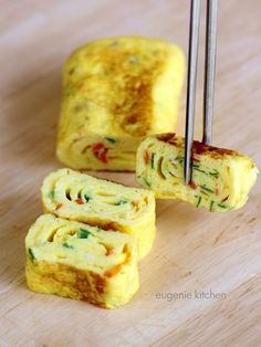 an omelet is being cut into pieces on a cutting board