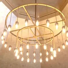 a chandelier with lots of light bulbs hanging from it's center circle