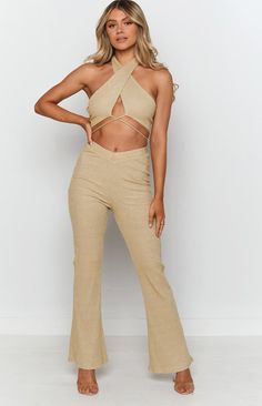 Gold Ribbed Pants Stand out in gold girl! These pants scream major 80s vibes, and we wouldn't have it any other way - pair with the matching crop top for the ultimate golden girl outfitFlared PantsHigh-waisted design that dips down slightly at the centreThick elastic waistbandInvisible zip at the backMidweight ribbed material with stretch Fitted Straight Leg Gold Pants, Gold Fitted Straight Leg Pants, Luxury Stretch Ribbed Pants, Non-stretch Ribbed Pants, Luxury Full-length Pants With Ribbed Waistband, Prom Midi Dress, Summer Playsuit, Gold Girl, Golden Girl