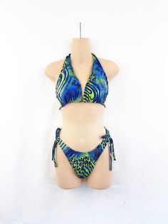 Great vintage shape.  No tag or size seen Fun suit! Let me know if you need any measurements :) Tropical Print Swimwear For Vacation Festival, One-piece Swimwear For Beach Festival, Festival Green Printed Swimwear, Tropical Print Beachwear Swimwear For Festival, Tropical Print Beachwear For Festival, Beach Season Tropical Print Halter Top For Pool, Tropical Print Halter Top For Pool And Beach Season, Tropical Print Halter Top For Beach Season, Green Halter Neck Swimwear For Festivals