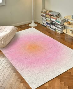 a pink and white rug in the middle of a room with a lamp on it