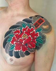 a man with a flower tattoo on his chest