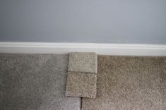 the corner of a room with carpeted walls