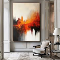 an abstract painting hangs on the wall above a chair and lamp in a living room