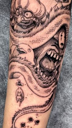 an arm with some tattoos on it and a dragon in the middle of it's head