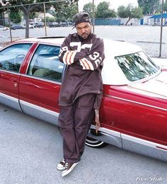 a man standing next to a parked car