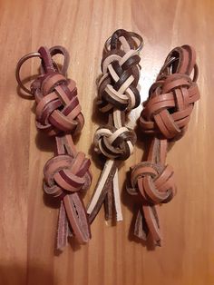 four pieces of leather tied together on a wooden table